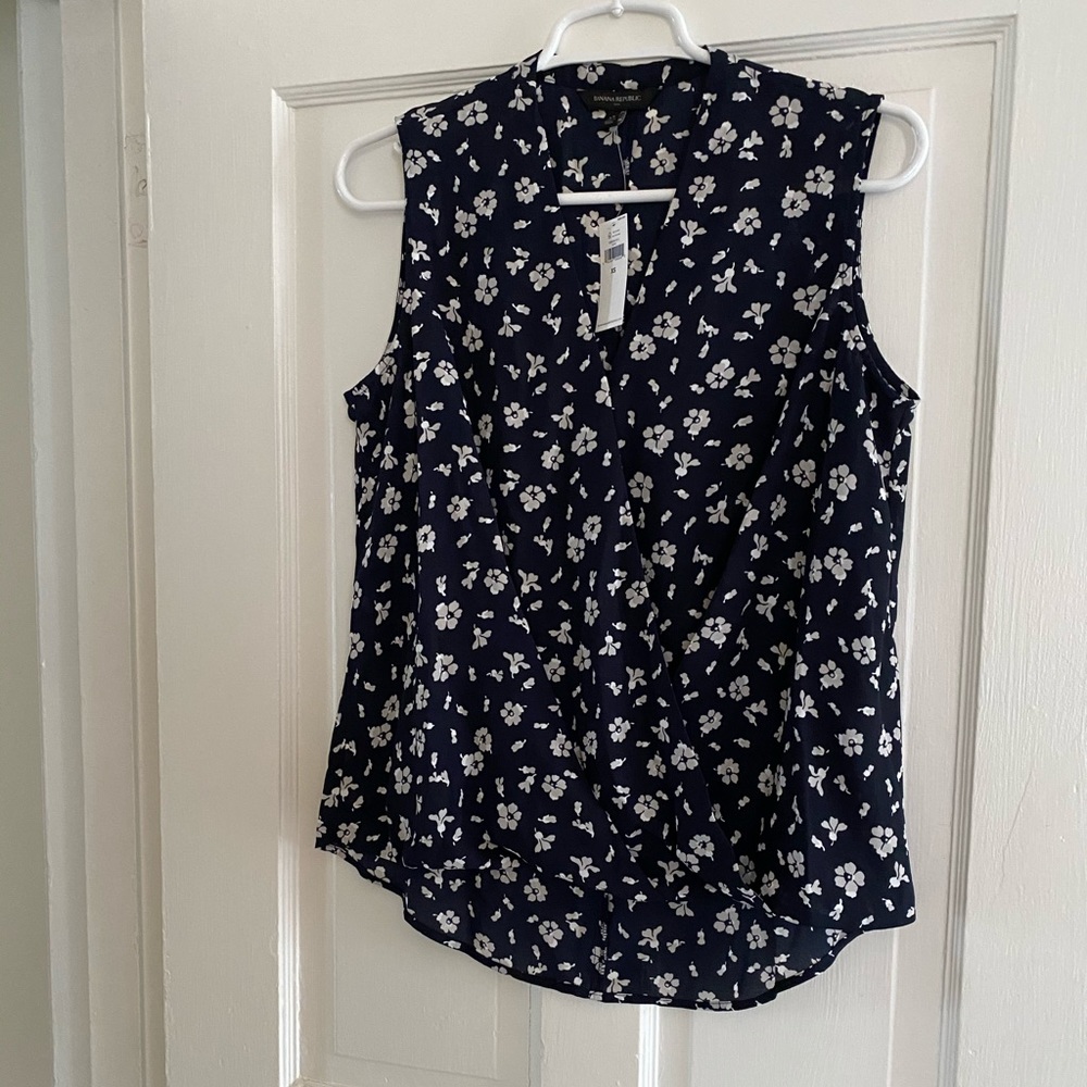 Blue and white sleeveless floral top.